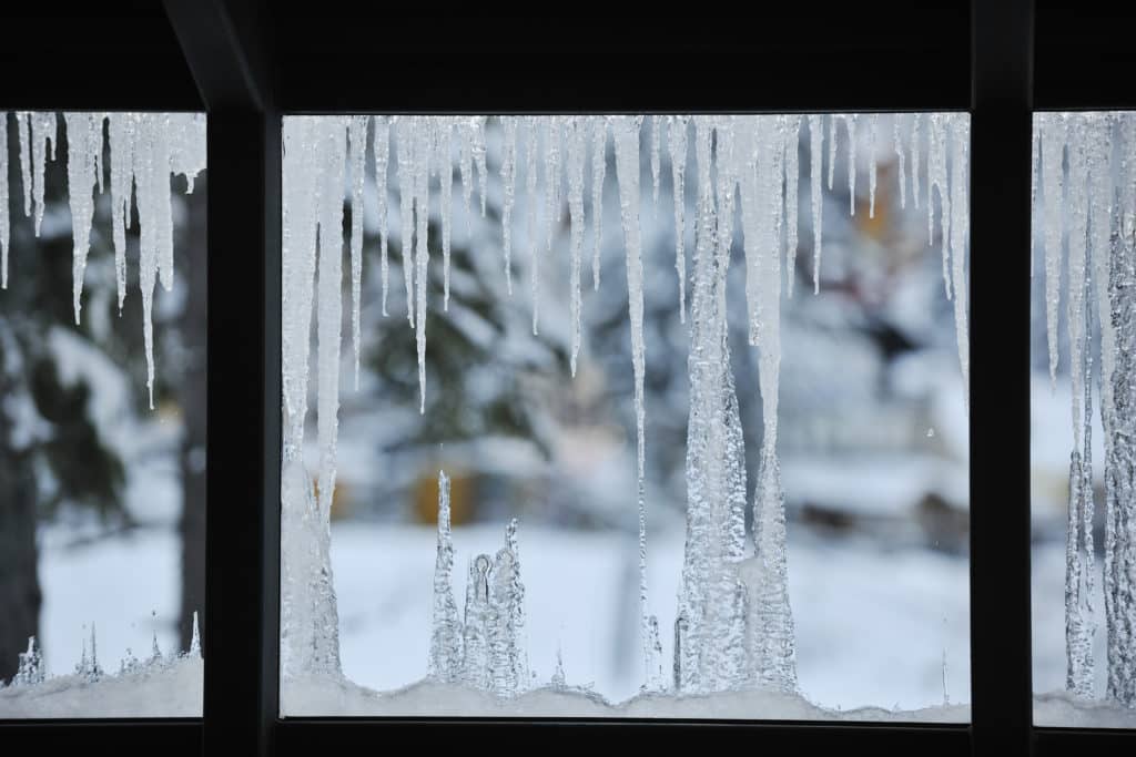An energy efficient window showing snow and ice outside.