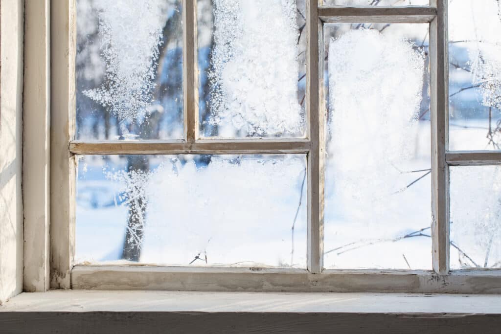 An energy efficient window with ice on it.